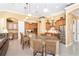 Bright, spacious kitchen boasts granite countertops, custom cabinets, and a large center island with seating at 14010 San Domingo Blvd, Port Charlotte, FL 33981