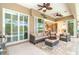 Relaxing lanai featuring comfortable seating, a ceiling fan, and seamless access to the living area at 14010 San Domingo Blvd, Port Charlotte, FL 33981