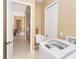 Well-lit laundry area featuring a washing machine, sink, and storage cabinetry at 14010 San Domingo Blvd, Port Charlotte, FL 33981