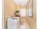 Bright laundry room with a washer, dryer, tiled floor, and ample natural light at 14010 San Domingo Blvd, Port Charlotte, FL 33981