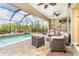Lanai featuring a pool, outdoor kitchen, comfortable seating, and scenic views at 14010 San Domingo Blvd, Port Charlotte, FL 33981