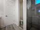 Bathroom featuring a toilet, shower, and white door at 14681 Keystone Blvd, Port Charlotte, FL 33981