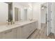 Double vanity bathroom with light wood cabinets and a walk-in shower at 14681 Keystone Blvd, Port Charlotte, FL 33981