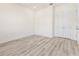Well-lit bedroom with wood-look floors and a double-door closet at 14681 Keystone Blvd, Port Charlotte, FL 33981