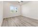 Light and airy bedroom featuring wood-look floors and large windows at 14681 Keystone Blvd, Port Charlotte, FL 33981