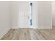 Light and bright entryway with wood-look flooring and white door at 14681 Keystone Blvd, Port Charlotte, FL 33981