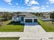 Single story home with three car garage, neutral color scheme, and lush lawn at 14681 Keystone Blvd, Port Charlotte, FL 33981