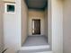 Modern front door entrance with a covered porch at 14681 Keystone Blvd, Port Charlotte, FL 33981