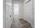 Bright hallway with white doors and gray flooring at 14681 Keystone Blvd, Port Charlotte, FL 33981