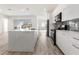 Modern kitchen with white cabinets, quartz countertops and island at 14681 Keystone Blvd, Port Charlotte, FL 33981
