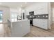 Modern kitchen with white cabinets, quartz countertops and island at 14681 Keystone Blvd, Port Charlotte, FL 33981