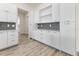 Modern kitchen with white cabinets and gray tile backsplash at 14681 Keystone Blvd, Port Charlotte, FL 33981