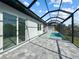 Covered patio with pool and gray tile deck at 14681 Keystone Blvd, Port Charlotte, FL 33981