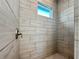Clean shower with neutral tile and a window for natural light at 14681 Keystone Blvd, Port Charlotte, FL 33981