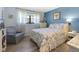 Bedroom with floral bedding, gray armchair, and wood-look floors at 1515 Forrest Nelson Blvd # A 202, Port Charlotte, FL 33952