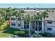 Attractive exterior of the building with palm trees and landscaping at 1515 Forrest Nelson Blvd # A 202, Port Charlotte, FL 33952