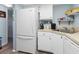 White kitchen with appliances, corner sink, and ample counter space at 1515 Forrest Nelson Blvd # A 202, Port Charlotte, FL 33952