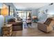 Living room with comfortable seating and a view to a balcony at 1515 Forrest Nelson Blvd # A 202, Port Charlotte, FL 33952