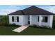 White house with black roof and windows, walkway, and landscaping at 1516 Birchcrest Blvd, Port Charlotte, FL 33952