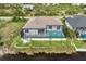 Aerial view showcasing home's pool, patio, and canal-front location at 15384 Hennipen Cir, Port Charlotte, FL 33981