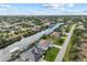 Aerial view of house and neighborhood near canal at 15384 Hennipen Cir, Port Charlotte, FL 33981