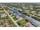 Aerial view showing home's location on canal with neighborhood context at 15384 Hennipen Cir, Port Charlotte, FL 33981