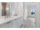 Double vanity bathroom with gray tile and vinyl flooring at 15384 Hennipen Cir, Port Charlotte, FL 33981