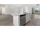 Modern kitchen island with sink, dishwasher, and white cabinets at 15384 Hennipen Cir, Port Charlotte, FL 33981