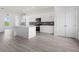 Modern white kitchen with gray tile backsplash and stainless steel appliances at 15384 Hennipen Cir, Port Charlotte, FL 33981