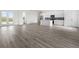 Open concept living area with kitchen and gray vinyl flooring at 15384 Hennipen Cir, Port Charlotte, FL 33981