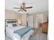 Bright bedroom with a queen bed, ceiling fan, and access to other rooms at 1570 Virginia Ln, Englewood, FL 34223