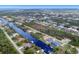 Wide aerial showcasing the neighborhood, canal, and the property's location at 15832 Hennipen Cir, Port Charlotte, FL 33981