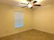 Well-lit bedroom with tile flooring and window coverings at 166 Rotonda N Blvd, Rotonda West, FL 33947