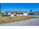 Single story home with a gray roof, white exterior and palm tree at 1740 Elinor Pl, Englewood, FL 34223