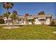 One-story home with a large yard, palm trees, and a screened porch at 1780 Elinor Pl, Englewood, FL 34223