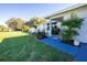 Inviting home exterior with a well-manicured lawn, colorful garden, and a freshly painted walkway leading to the front door at 18497 Kuldin Ave, Port Charlotte, FL 33948