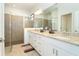 Double vanity bathroom with granite countertop and large shower at 19584 Fishhawk Trl, Venice, FL 34293