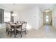 Dining area with a wood table, chairs, and a modern chandelier at 19584 Fishhawk Trl, Venice, FL 34293