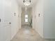 Bright and airy entryway with tile flooring and a chandelier at 19584 Fishhawk Trl, Venice, FL 34293
