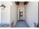 Front entry with brick walkway and chandelier-lit interior view at 19584 Fishhawk Trl, Venice, FL 34293