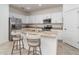 Modern kitchen with white cabinets, granite counters, and stainless steel appliances at 19584 Fishhawk Trl, Venice, FL 34293