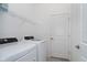 Laundry room with washer, dryer, and shelving at 19584 Fishhawk Trl, Venice, FL 34293