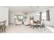 Open floor plan living room with light beige furniture and tile flooring at 19584 Fishhawk Trl, Venice, FL 34293