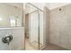 Walk-in shower with glass enclosure and gray tile at 19584 Fishhawk Trl, Venice, FL 34293