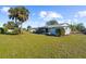 Spacious backyard with grassy lawn and palm trees at 2191 Morley St, Port Charlotte, FL 33952