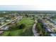 Aerial view of a neighborhood bordering a golf course at 229 Medalist Rd, Rotonda West, FL 33947