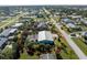 An aerial view of a single Gathering home with a screened in pool at 2495 Tenth St, Englewood, FL 34224