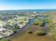 Wide aerial view of waterfront community with lush landscaping at 2495 Tenth St, Englewood, FL 34224