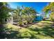 Tropical backyard with pool and lush landscaping at 2495 Tenth St, Englewood, FL 34224