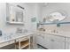 Vanity with white cabinets and a large mirror in a well lit bathroom at 2495 Tenth St, Englewood, FL 34224